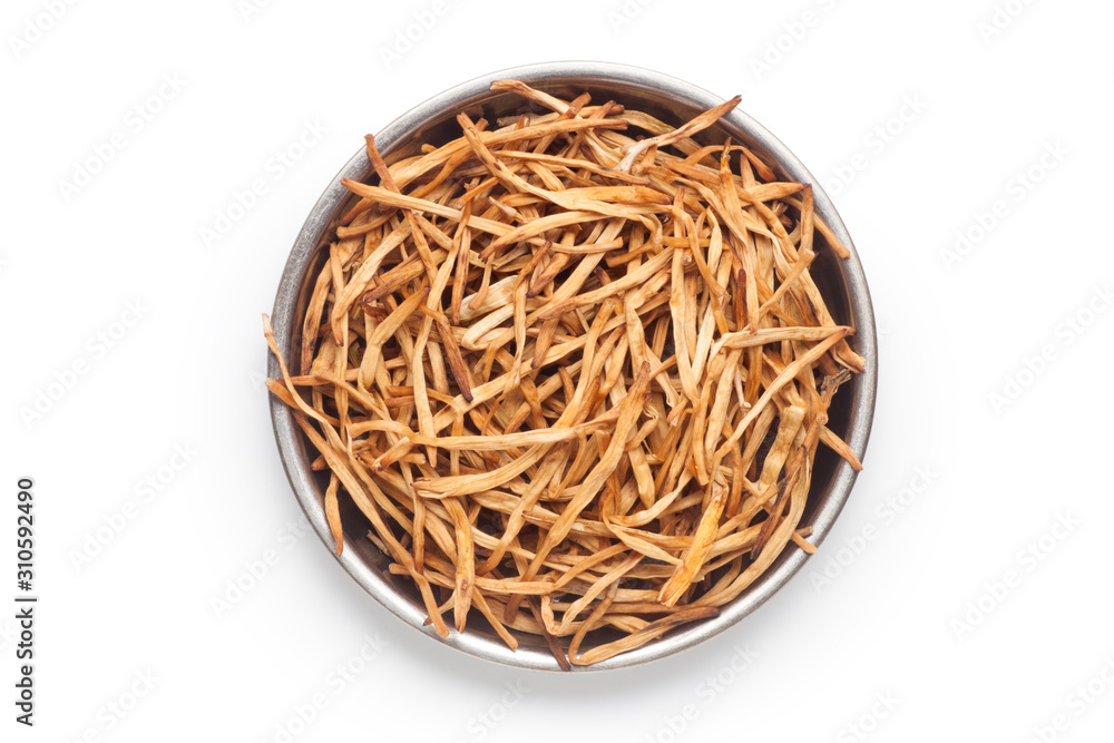 Dried daylily flower in a metal plate, Isolated on white background. Top view. Dried daylily flower in a metal plate, Isolated on white background. Top view.
