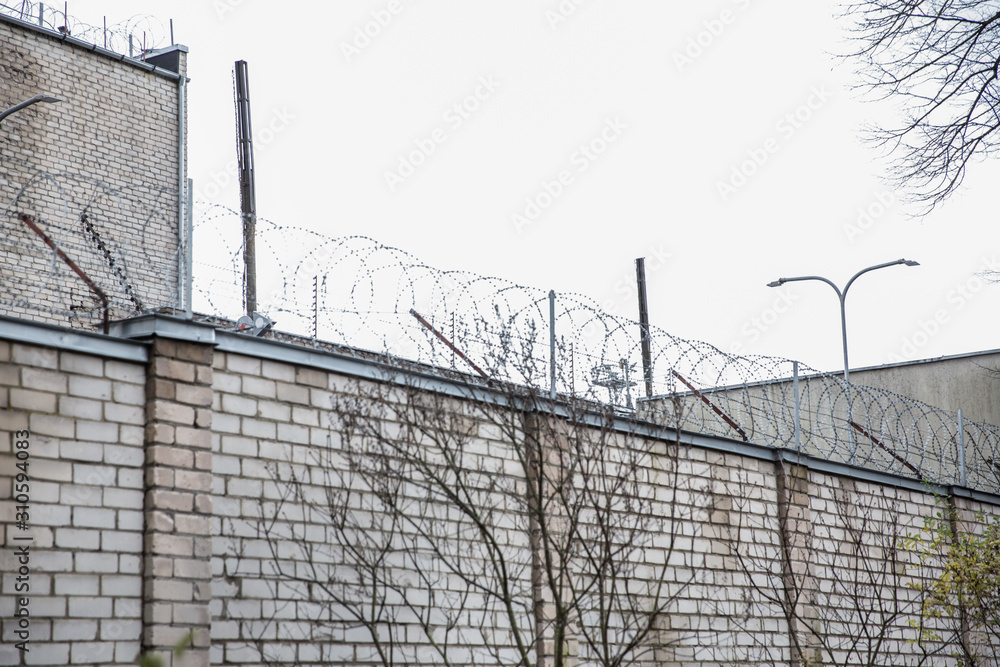 Prison or protected area. High brick walls with barbed wire. Prison or protected area. High brick walls with barbed wire.