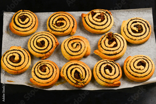 Baked cookies with raisins and poppy seeds on a trail.