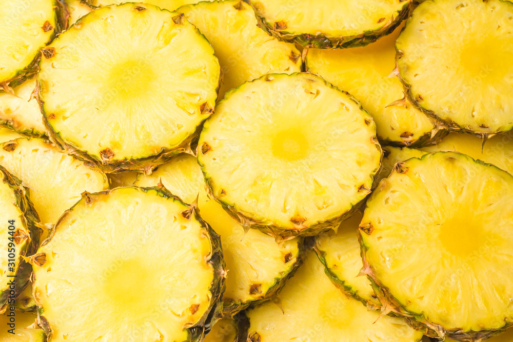 Pineapple juicy yellow slices background. Top view. Pineapple juicy yellow slices background. Top view.