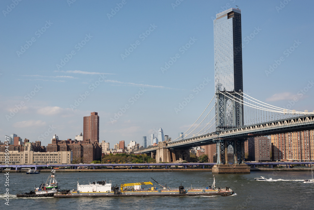 Obraz premium The Manhattan Bridge with Manhattan's Lower East Side and Two Bridges neighborhoods in the background. Taken in New York City on the 28th of September, 2019.