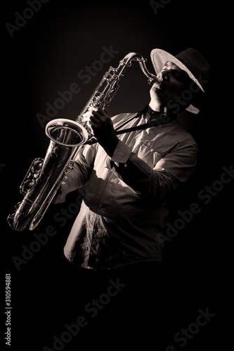 Canvas Print Saxophone Player in Concert - black and white isolated on black background