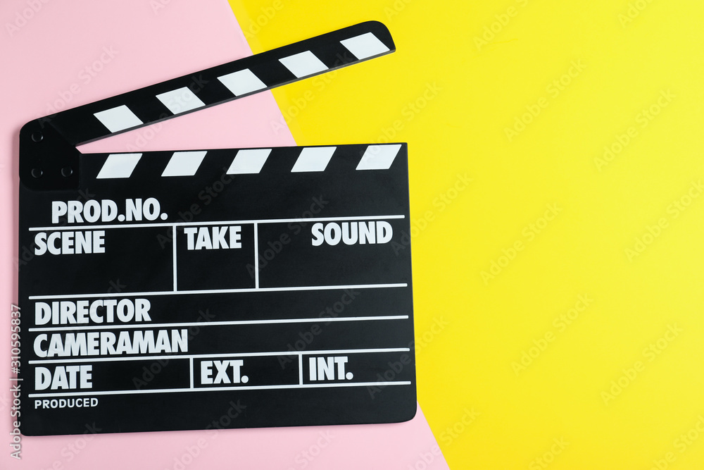 Clapper board on color background, top view with space for text. Cinema production