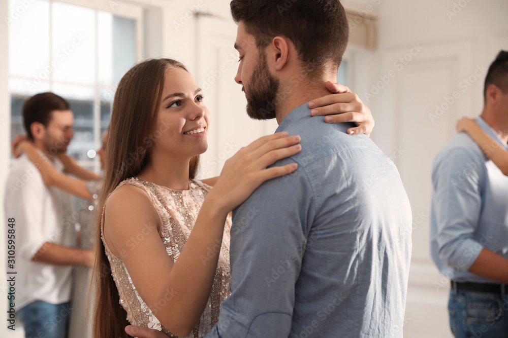 Fototapeta premium Lovely young couple dancing together at party