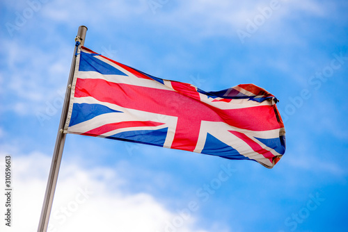 Flag of united kingdom fluttering on a metal flagpole