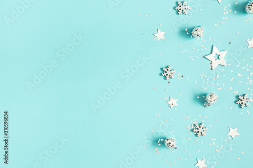 Fototapeta Naklejka Na Ścianę i Meble -  Christmas composition. Silver decorations on pastel blue background. Christmas, winter, new year concept. Flat lay, top view, copy space