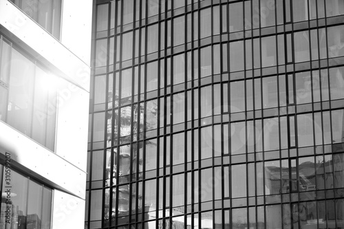 Wallpaper Mural Sun rays light effects on urban buildings in sunset. Modern office building detail, glass surface with sunlight. Business background. Black and white. Torontodigital.ca