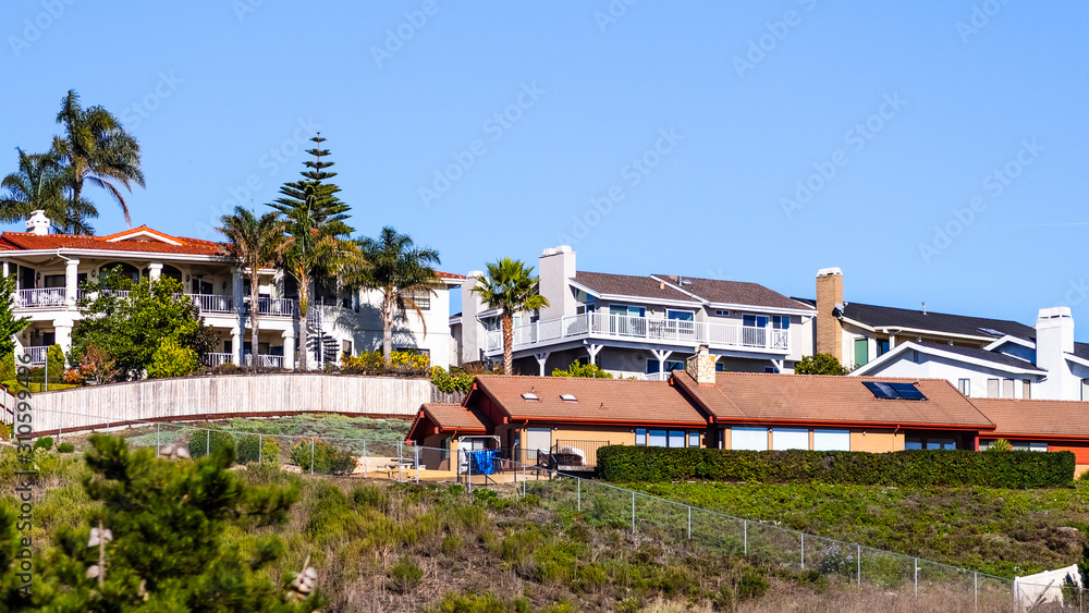 Residential neighborhood with houses built on a hill, Pismo Beach, California Residential neighborhood with houses built on a hill, Pismo Beach, California