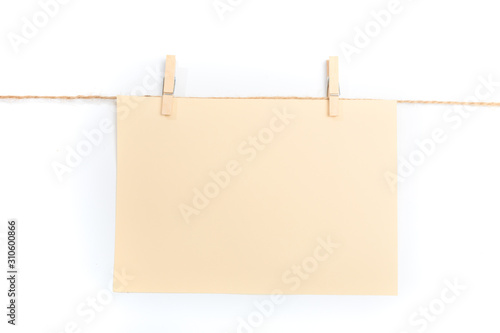 paper blank note hanging on the rope with wooden clothespins isolated on white background - Image