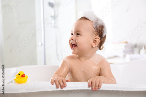 Konstfotografi Cute little baby in bathtub at home