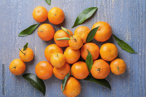 Fresh ripe tangerines on grey wooden table, flat lay