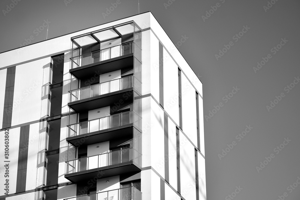 Sun rays light effects on urban buildings. Fragment of modern residential apartment with flat buildings exterior. Detail of new luxury house and home complex. Black and white. Sun rays light effects on urban buildings. Fragment of modern residential apartment with flat buildings exterior. Detail of new luxury house and home complex. Black and white.