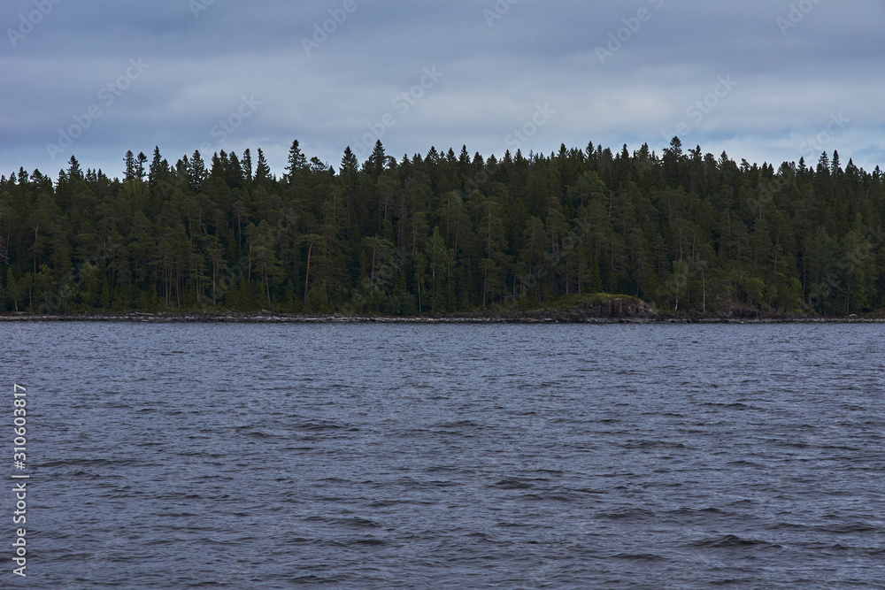 The nature of Karelia.Typical Karelian landscape on the island of Valaam: forest of conifers, Lake Ladoga, crag and volcanic rocks. Russia, Karelia The nature of Karelia.Typical Karelian landscape on the island of Valaam: forest of conifers, Lake Ladoga, crag and volcanic rocks. Russia, Karelia