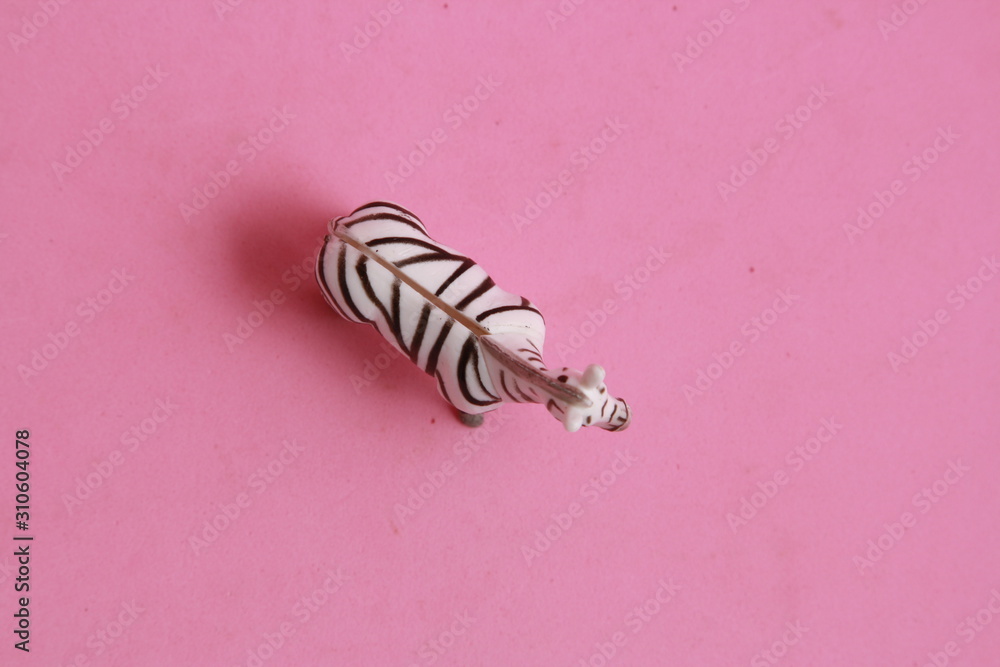 plastic toy with zebra shape in color background plastic toy with zebra shape in color background