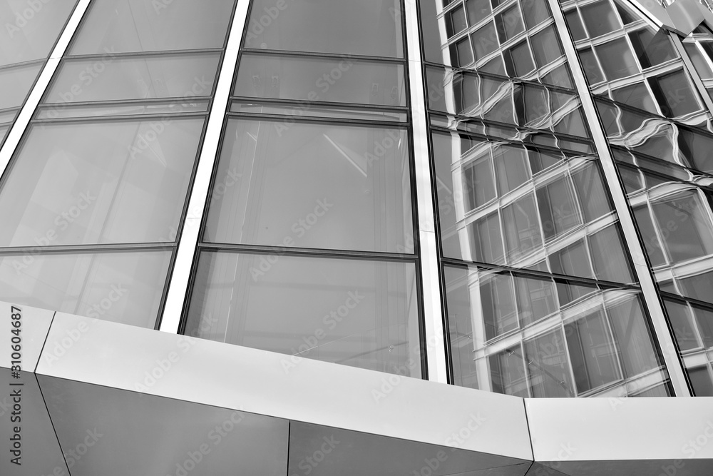 Sun rays light effects on urban buildings in sunset. Modern office building detail, glass surface with sunlight. Business background. Black and white. Sun rays light effects on urban buildings in sunset. Modern office building detail, glass surface with sunlight. Business background. Black and white.