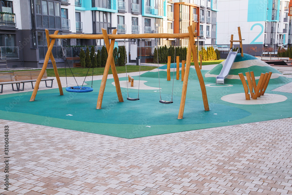 Public playground for kids in the local area among apartment buildings - obrazy, fototapety, plakaty 