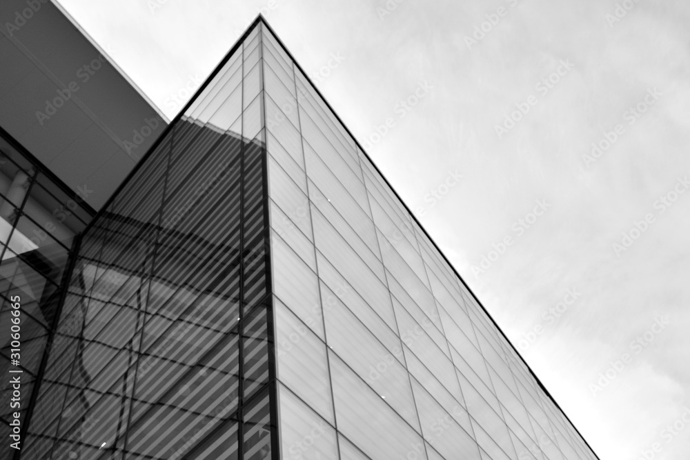 Sun rays light effects on urban buildings in sunset. Modern office building detail, glass surface with sunlight. Business background. Black and white. Sun rays light effects on urban buildings in sunset. Modern office building detail, glass surface with sunlight. Business background. Black and white.