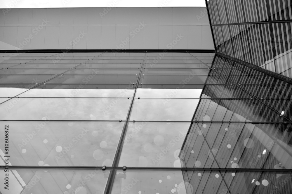 Sun rays light effects on urban buildings in sunset. Modern office building detail, glass surface with sunlight. Business background. Black and white. Sun rays light effects on urban buildings in sunset. Modern office building detail, glass surface with sunlight. Business background. Black and white.
