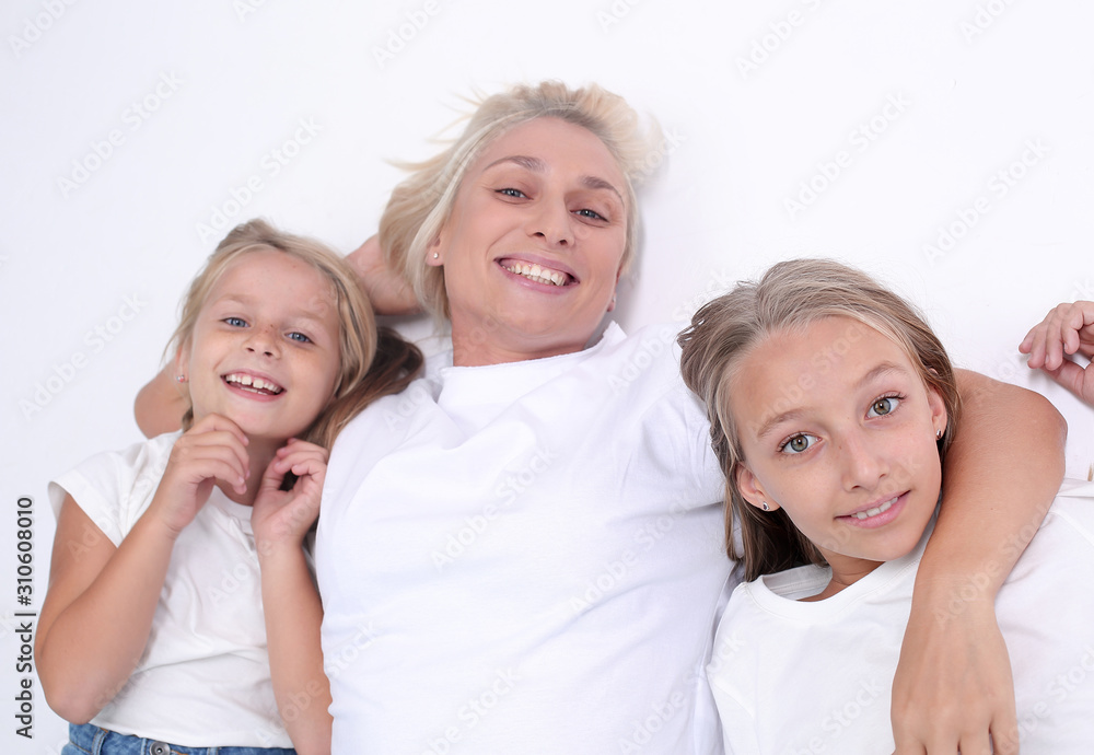 happy mom with her two daughters looking at the camera happy mom with her two daughters looking at the camera