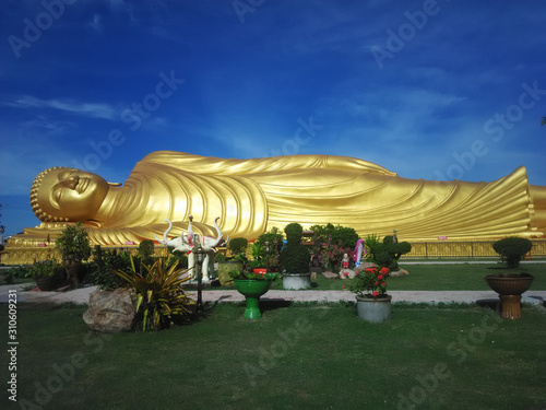 Beautiful Golden Reclining Buddha in Wat Phra Non Wat Laem Pho on Koh Yo island in Songhkla near Hat Yai, Thailand. One of the biggest sleeping Buddha statues in Thailand.  photo