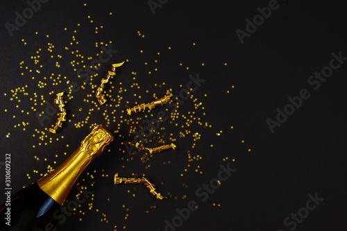 Creative concept photo of champagne bottle with star confetti