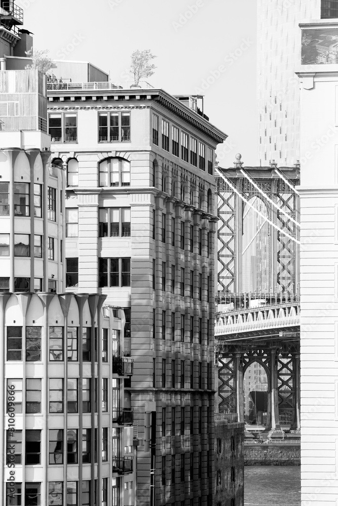 Black and white glimpse of the Manhattan Bridge as seen through Brooklyn's Main Street from the Brooklyn Bridge. Taken in New York City on September the 28th, 2019