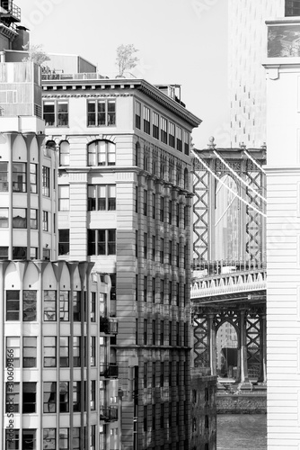 Black and white glimpse of the Manhattan Bridge as seen through Brooklyn's Main Street from the Brooklyn Bridge. Taken in New York City on September the 28th, 2019