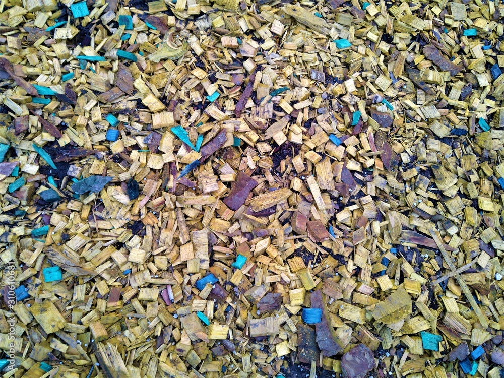 Yellow and blue wood shavings on the brown earth scattered Yellow and blue wood shavings on the brown earth scattered