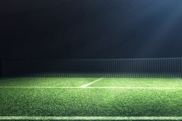 View of a tennis court with light from the spotlights