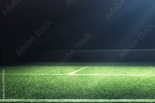 Fotografie View of a tennis court with light from the spotlights