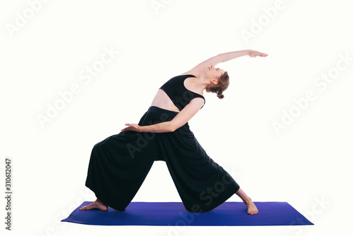Photo of young woman doing yoga reverse warrior pose over white background