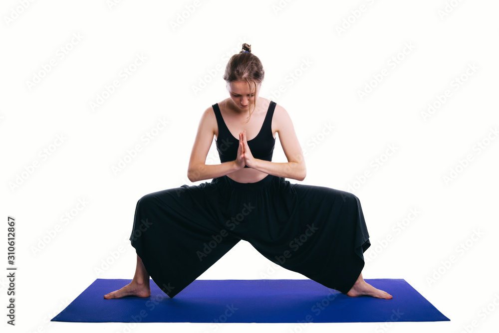 Photo of young woman doing yoga Goddess pose over white background
