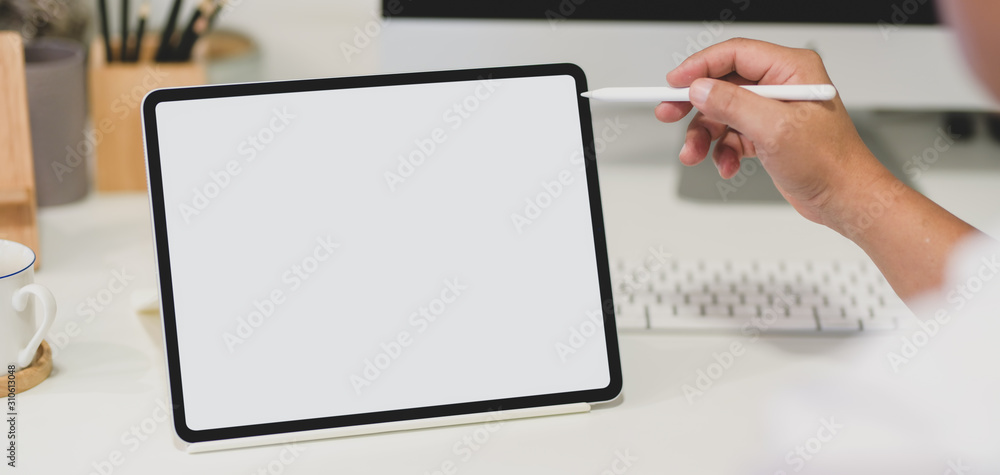 Close-up view of young man holding blank screen tablet Close-up view of young man holding blank screen tablet