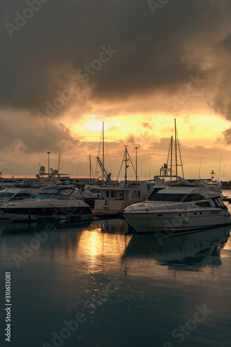 beautiful white boats and yachts against the backdrop of a beautiful sunset in a quiet bay of the Sochi sea port, Russia © westermak15