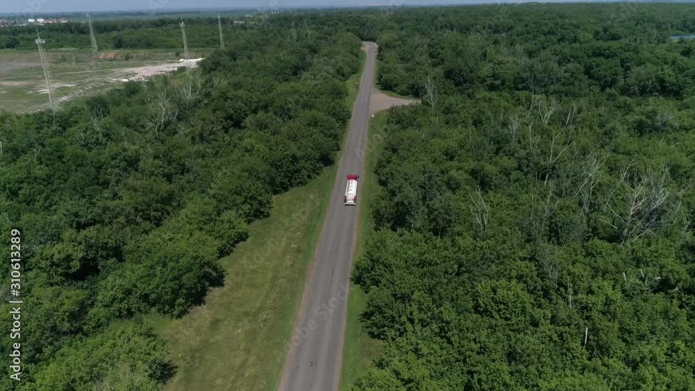 Aerial View of White Truck Passing Busy highway Aerial View of White Truck Passing Busy highway