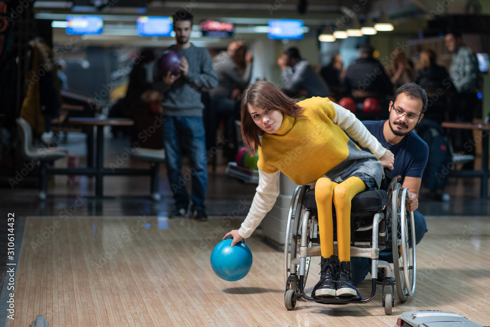 Disabled woman in a wheelchair bowling - obrazy, fototapety, plakaty 