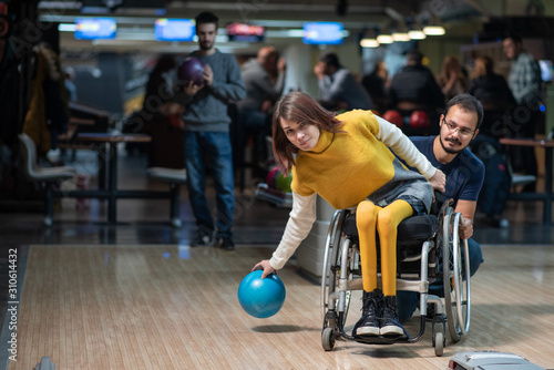 Disabled woman in a wheelchair bowling