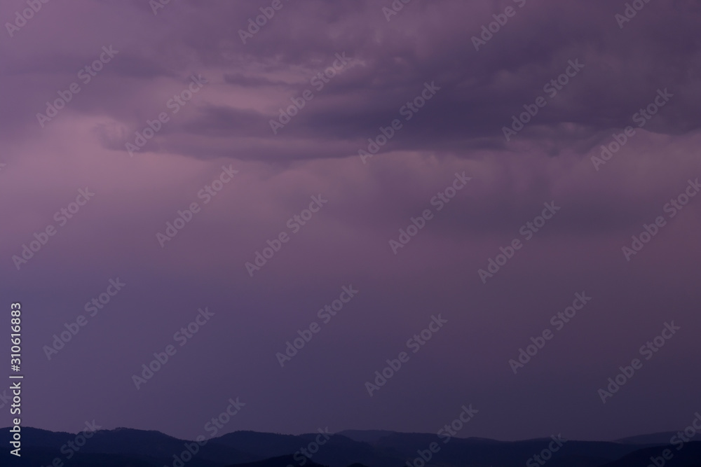 Stormy night sky over the mountain plateau background.