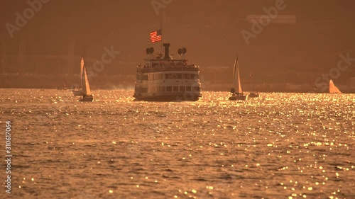 Ferry cruising in San Diego harbor at sunset photo