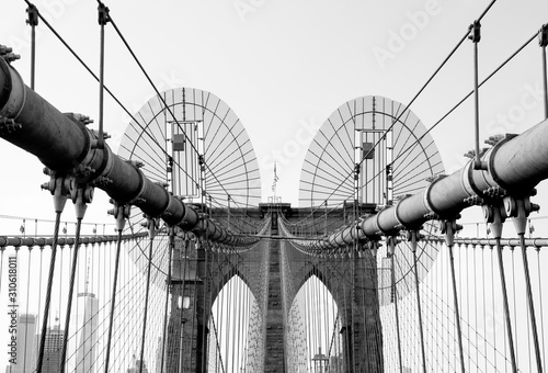 Black and white detail view of Brooklyn Bridge's suspender cables and wires next to one of its towers. Taken in New York City on September the 28th, 2019