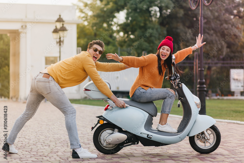 Inspired girl in trendy red hat spending time with boyfriend and