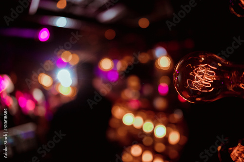 Electric lamp, bottom view. The concept of a decorative retro lamp with a view of the Edison bulb from below. Golden light photo