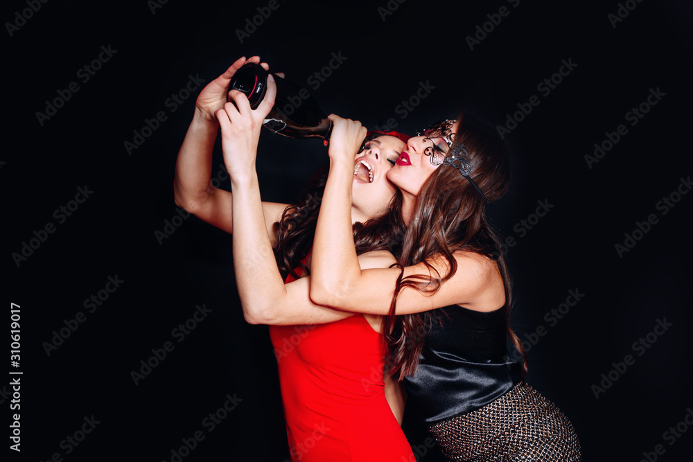 Two girls having fun drinking wine together Two girls having fun drinking wine together