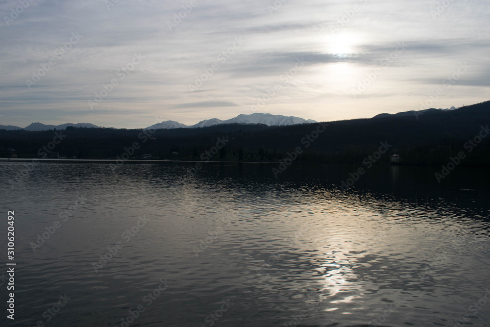 Sunset over a lake with calm waters Sunset over a lake with calm waters