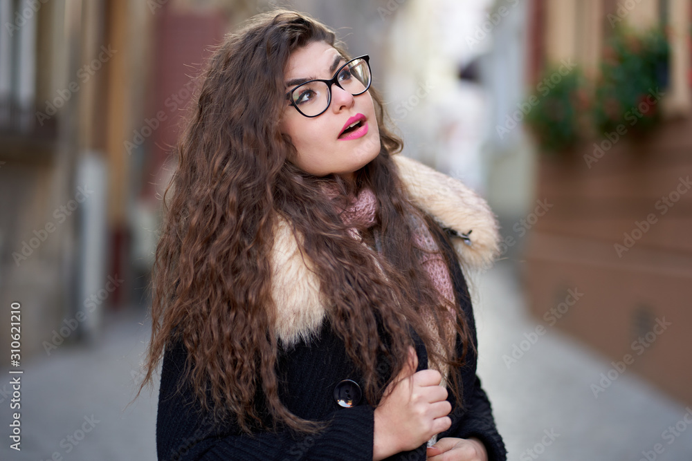 Curly haired young woman outdoor, closeup Curly haired young woman outdoor, closeup