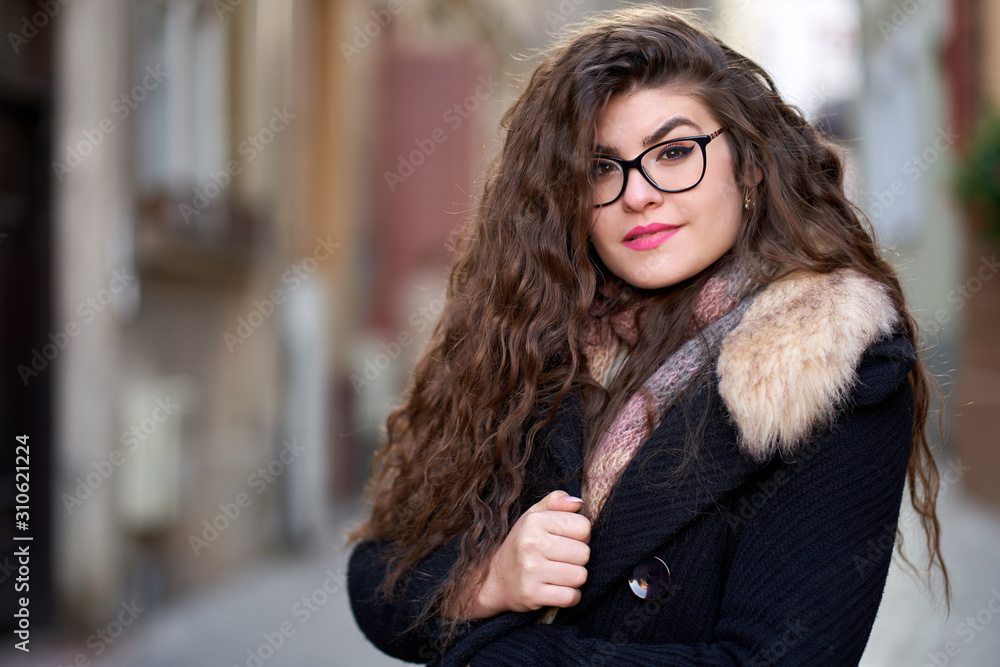 Curly haired young woman outdoor, closeup Curly haired young woman outdoor, closeup