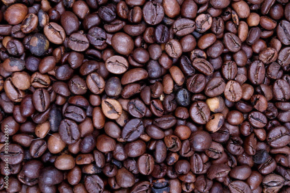 coffee beans with burlap sack on wooden background coffee beans with burlap sack on wooden background