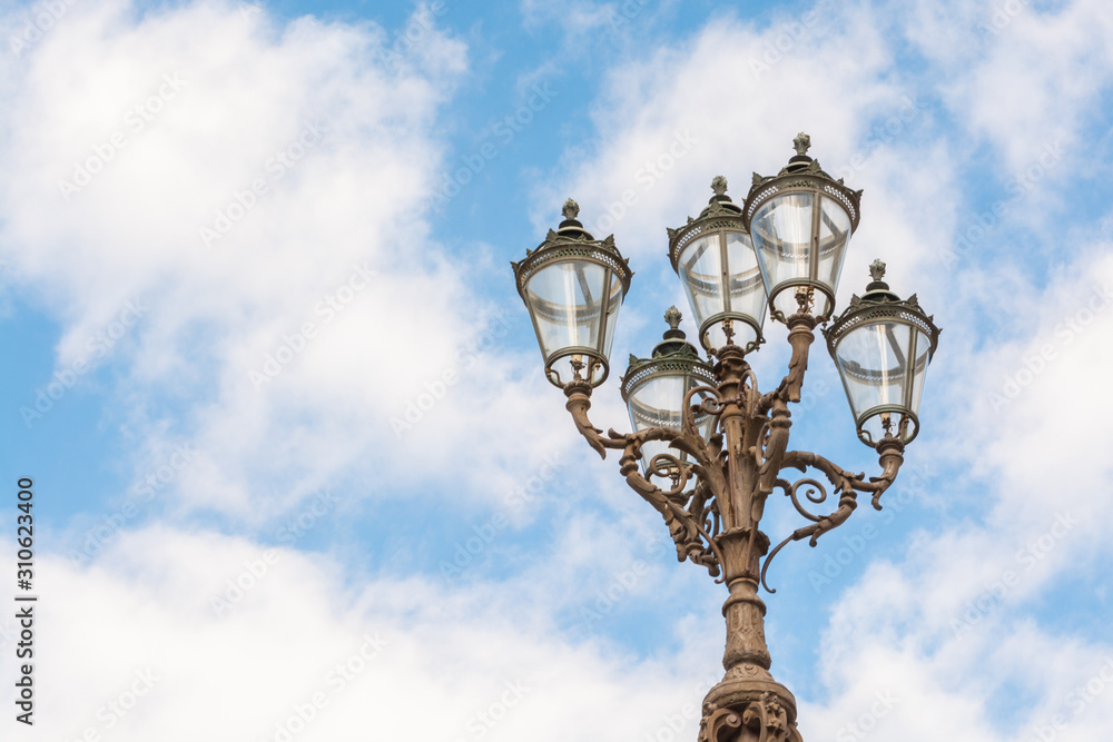 Florence old-styled street lamp on blue sky background