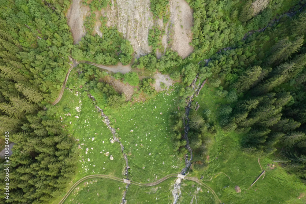 Hiking path in mountains over creek in the Alps