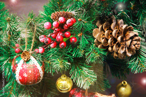festive multi-colored toys balls, cones, tree branches and decor